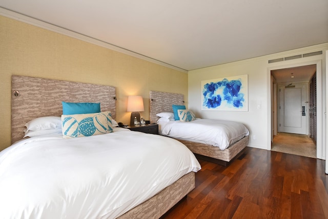 bedroom featuring ornamental molding and dark wood-type flooring