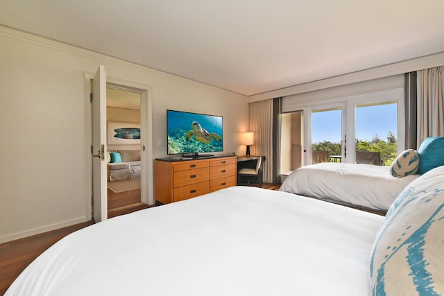 bedroom featuring dark hardwood / wood-style floors, crown molding, and access to outside