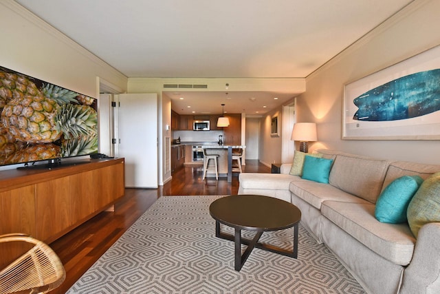 living room featuring dark hardwood / wood-style floors and ornamental molding