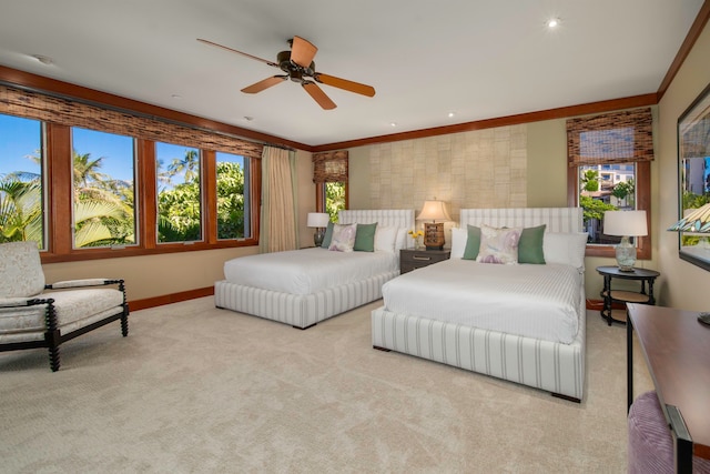 bedroom featuring ceiling fan, crown molding, and light carpet