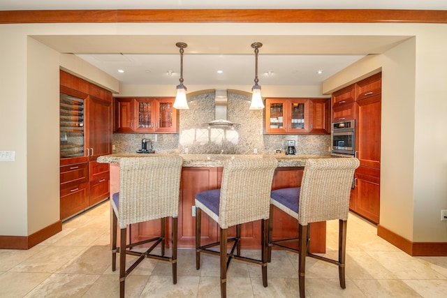 kitchen featuring wall chimney exhaust hood, decorative light fixtures, oven, and backsplash