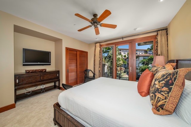 bedroom with ceiling fan, light colored carpet, a closet, and access to exterior