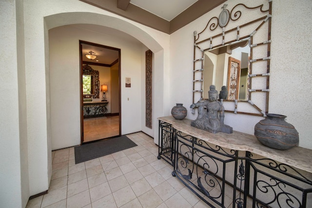 interior space featuring ornamental molding and light tile patterned floors