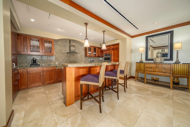 kitchen featuring pendant lighting, wall chimney exhaust hood, backsplash, and oven