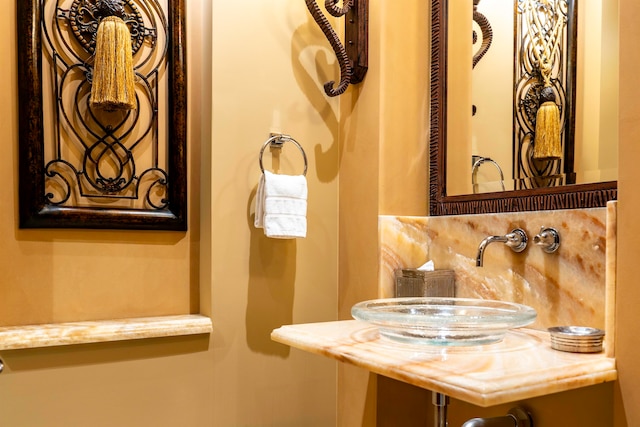 bathroom with tasteful backsplash and sink