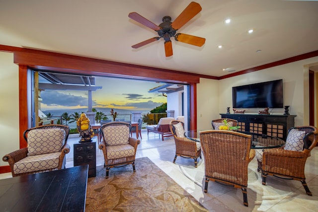 living room featuring ceiling fan and ornamental molding