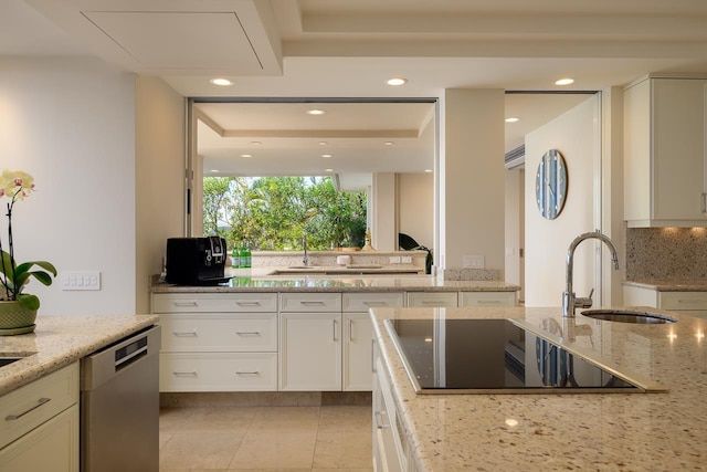 kitchen featuring light stone countertops, sink, white cabinets, and stainless steel dishwasher