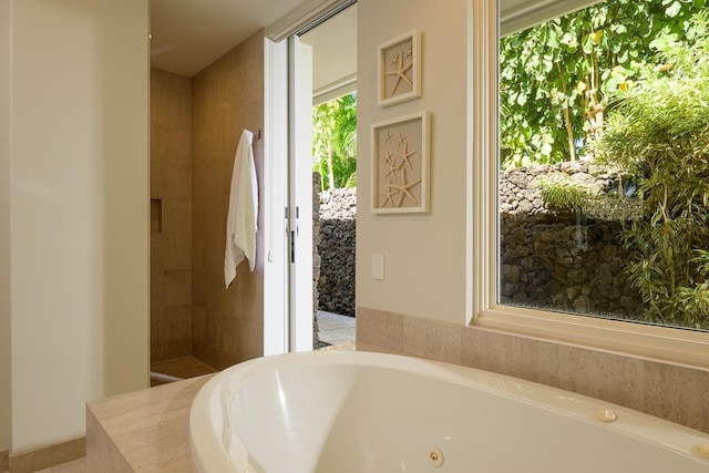 bathroom featuring tiled bath