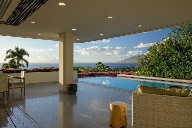 view of swimming pool with a mountain view and a patio