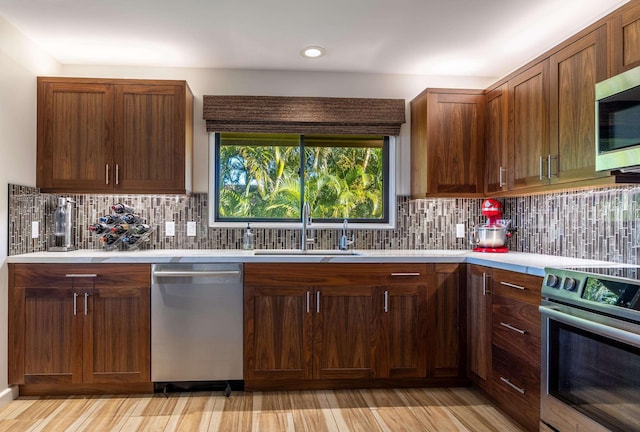 kitchen featuring sink, stainless steel appliances, and tasteful backsplash