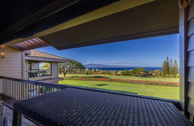 deck featuring a lawn and a water view