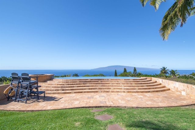 view of patio with a water view