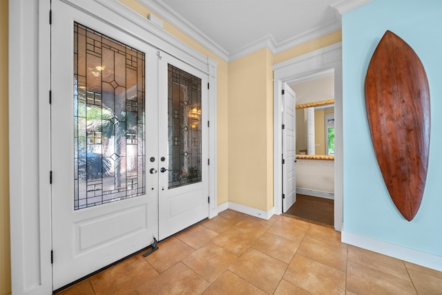 entryway featuring french doors, light tile patterned floors, and ornamental molding