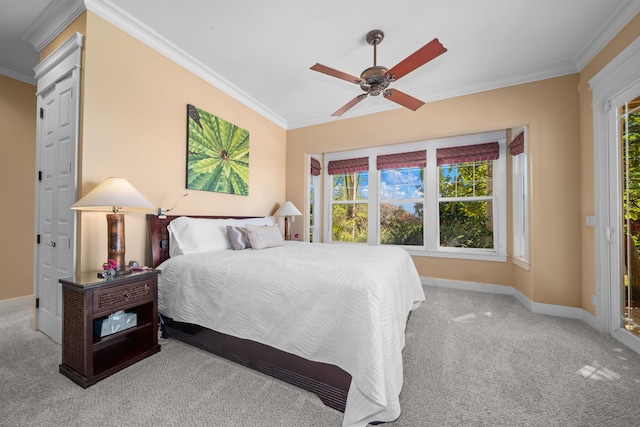 carpeted bedroom with multiple windows, ornamental molding, and ceiling fan