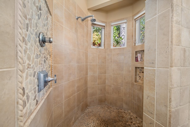 bathroom with tiled shower