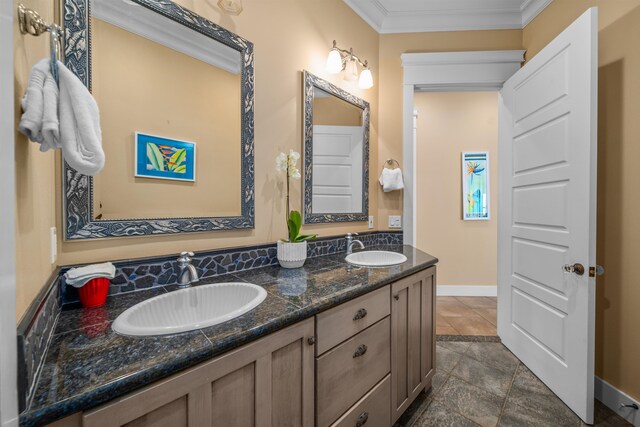 bathroom with vanity and ornamental molding