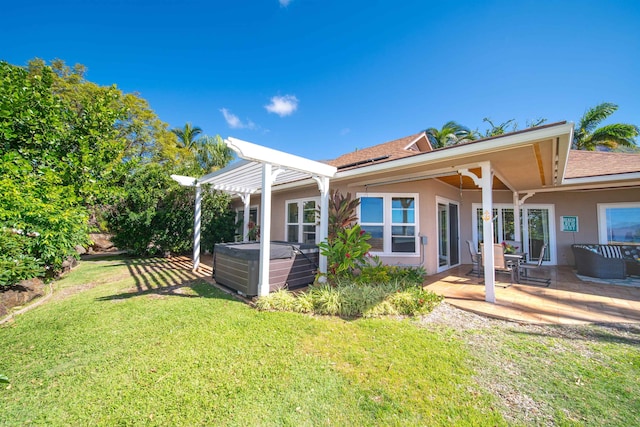 back of property featuring central AC unit, a patio area, a yard, and a hot tub