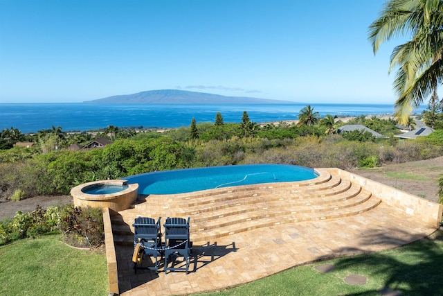 view of pool featuring an in ground hot tub and a water and mountain view