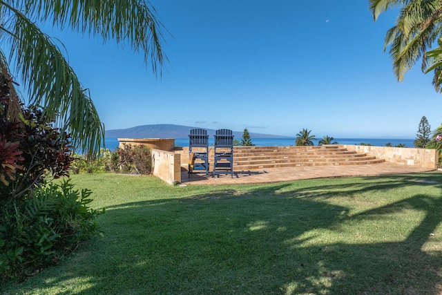 view of yard with a water and mountain view