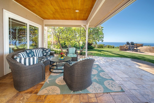 view of patio with outdoor lounge area and a water view