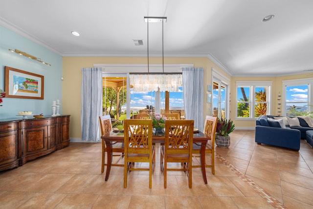 dining space with light tile patterned floors, crown molding, and a notable chandelier