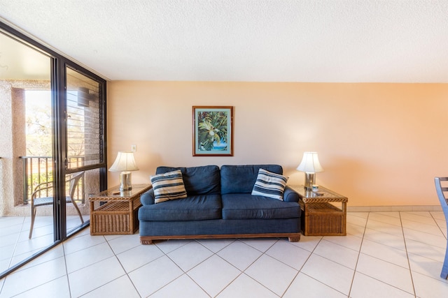 living room with light tile patterned floors, a textured ceiling, plenty of natural light, and floor to ceiling windows