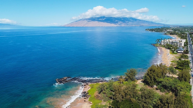 birds eye view of property with a water and mountain view