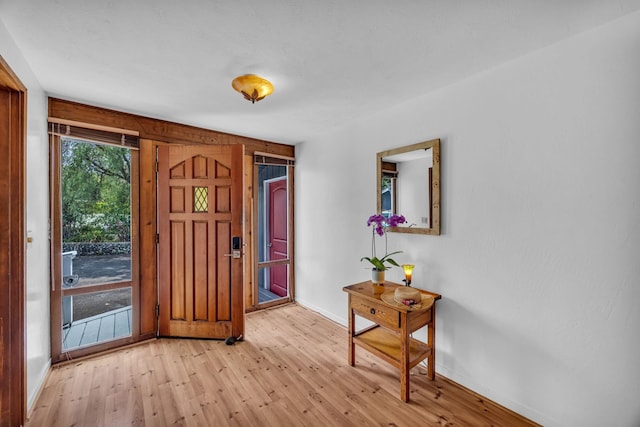 foyer featuring baseboards and light wood finished floors