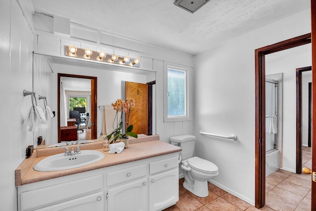 full bathroom featuring tile patterned floors, plenty of natural light, vanity, and toilet
