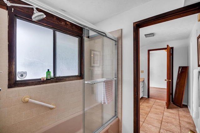 bathroom with tile patterned floors and combined bath / shower with glass door