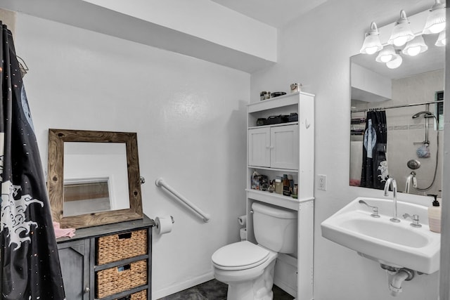 bathroom with toilet, curtained shower, a sink, and tile patterned floors