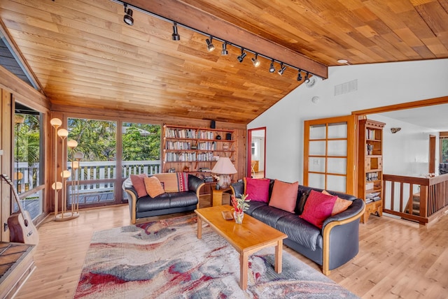 living room with wood ceiling, lofted ceiling with beams, rail lighting, and plenty of natural light