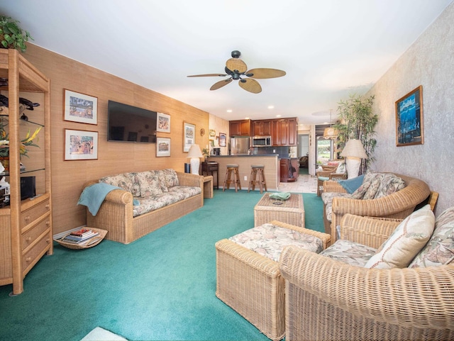 carpeted living room featuring ceiling fan