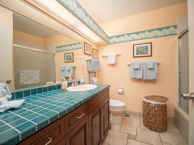 full bathroom featuring bath / shower combo with glass door, toilet, tile patterned floors, and vanity