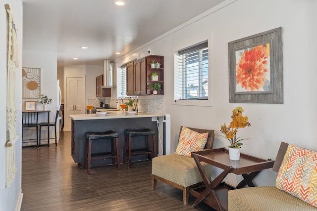 sitting room with recessed lighting and dark wood-style flooring