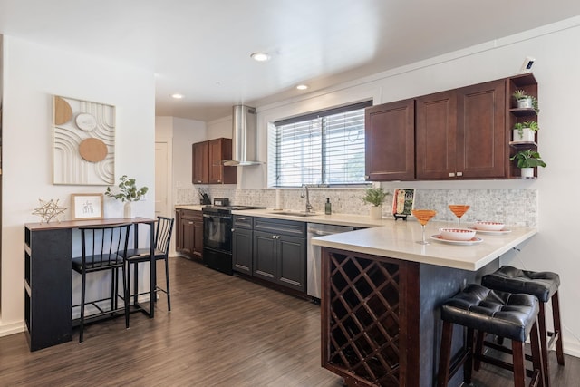 kitchen with a sink, black electric range, stainless steel dishwasher, wall chimney exhaust hood, and a kitchen bar