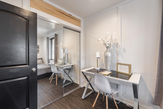 home office featuring baseboards and wood finished floors