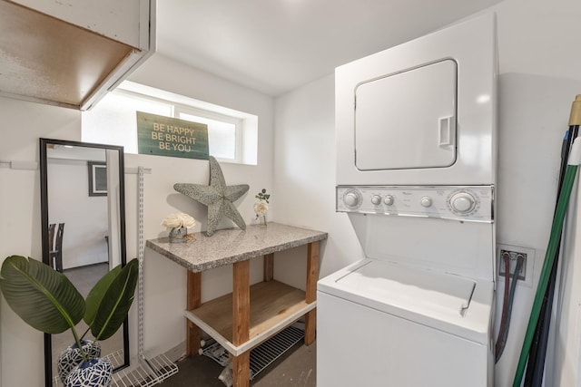 laundry room featuring laundry area and stacked washer / dryer