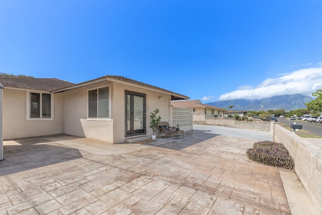 view of patio featuring fence and a mountain view