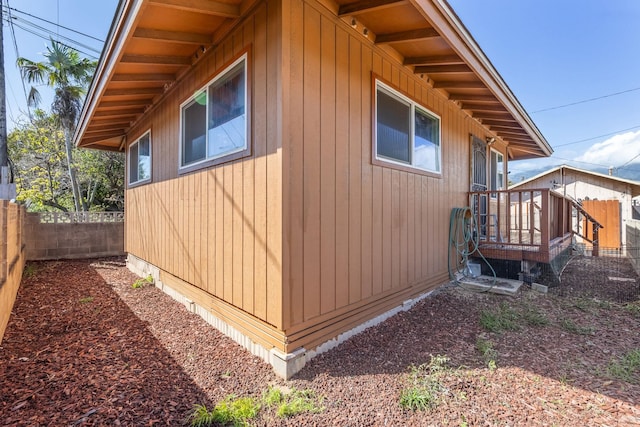 view of side of property featuring fence