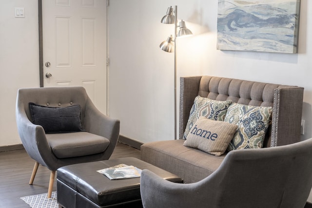 sitting room featuring baseboards and wood finished floors