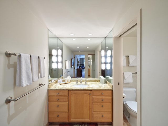 bathroom featuring tile patterned floors, vanity, and toilet