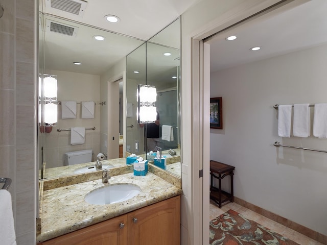 bathroom featuring tile patterned floors, vanity, and toilet