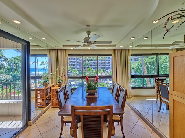 sunroom with a tray ceiling and ceiling fan