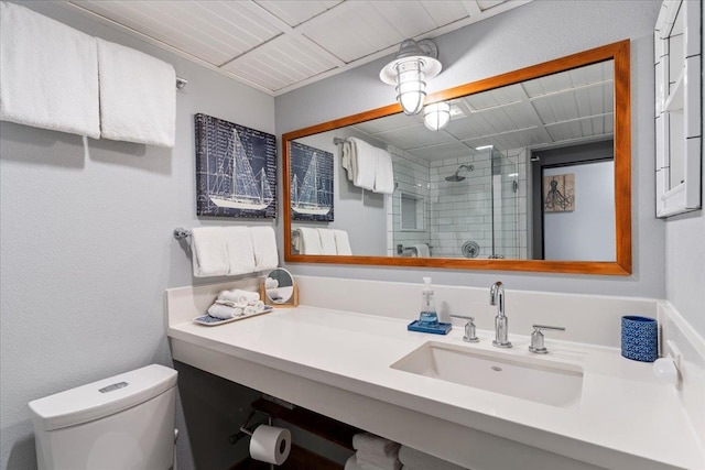 bathroom featuring vanity, toilet, and a shower with shower door