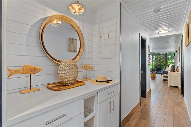 interior space with ornamental molding and wood-type flooring