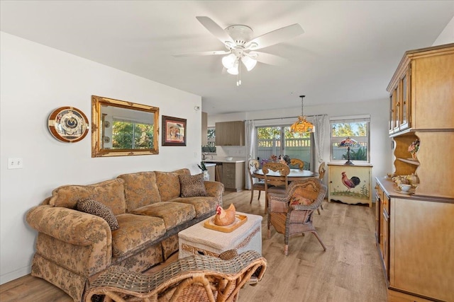 living room with light hardwood / wood-style floors and ceiling fan