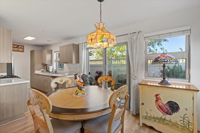 dining room featuring light hardwood / wood-style floors and sink