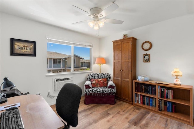 office space featuring a wall mounted AC, ceiling fan, and light hardwood / wood-style flooring