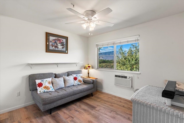 living room featuring an AC wall unit, ceiling fan, and hardwood / wood-style flooring